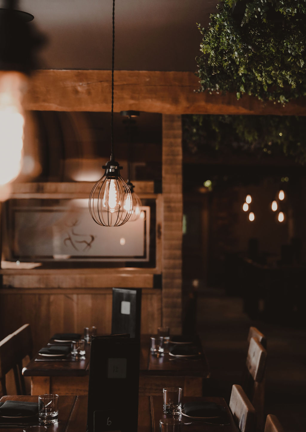 hanging light over a table with a wooden divider in the background