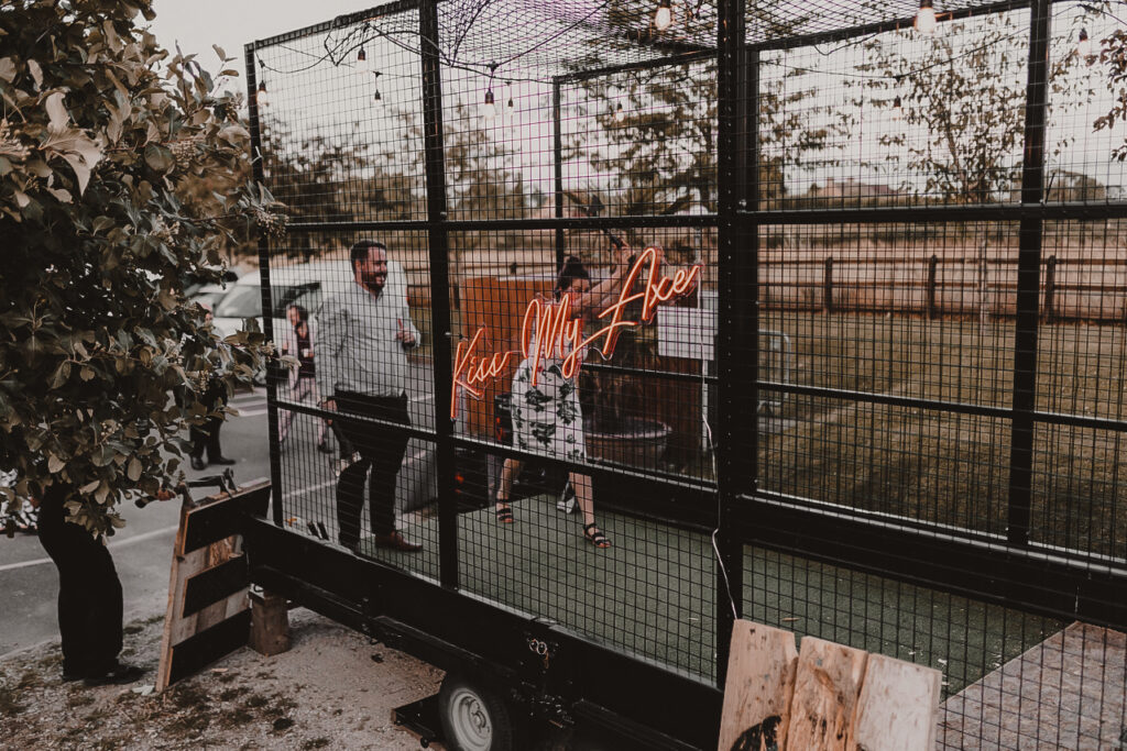 Two people axe throwing on an axe trailer